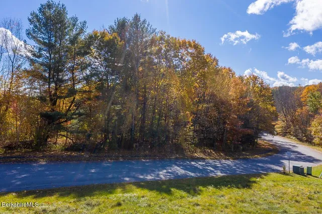 a front view of a house with a yard garden and outdoor seating