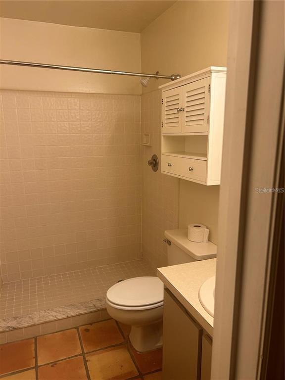 5115 Southwest 92nd Court Gainesville, FL 32608 - Photo 12 of 15 a bathroom with a toilet a sink and shower