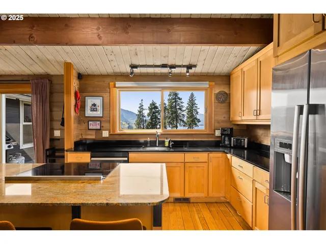 a view of a living room and kitchen with a large window