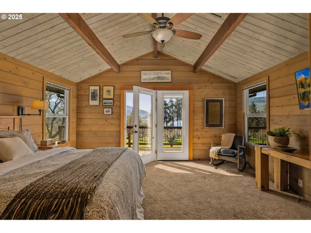 a bedroom with a bed a flat screen tv and balcony