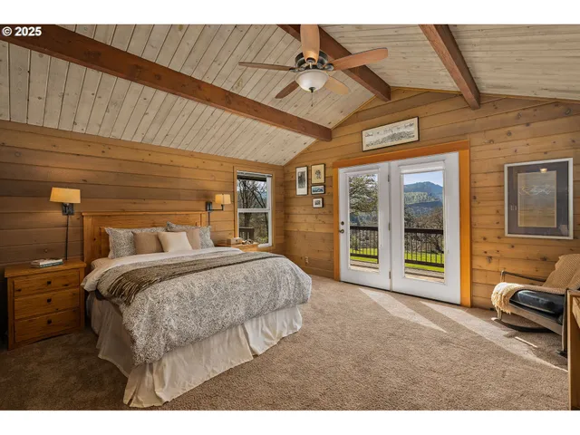 a bed room with a bed and a chair