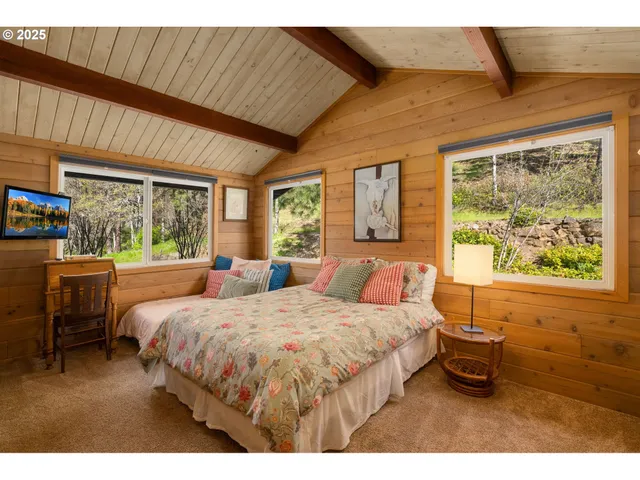 a bedroom with a large bed and a large window