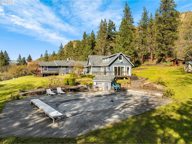 a view of a house with swimming pool and sitting area