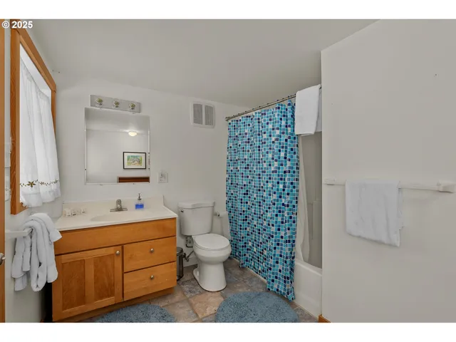 a bathroom with a sink toilet a mirror and shower