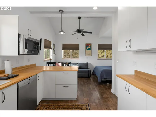 a kitchen with a sink dishwasher a stove a microwave oven with cabinets