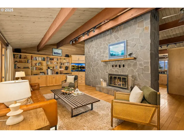 a living room with furniture a fireplace and a table