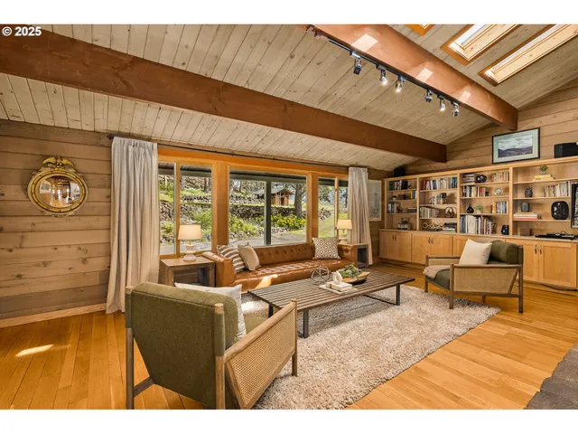 a living room with furniture and large window