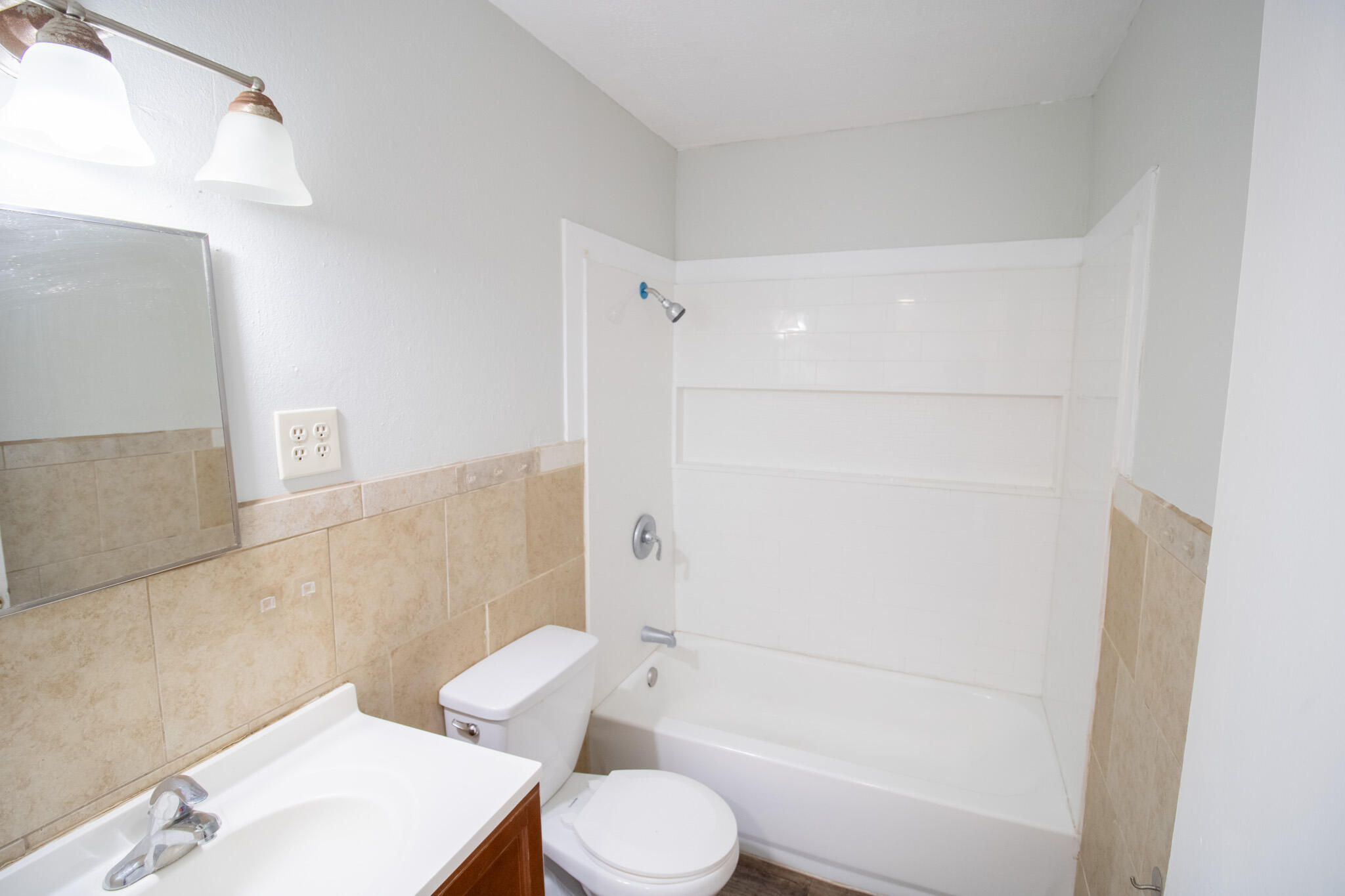 2906 43rd Street, Unit B Lubbock, TX 79413 - Photo 4 of 8 a bathroom with a toilet and a bath tub