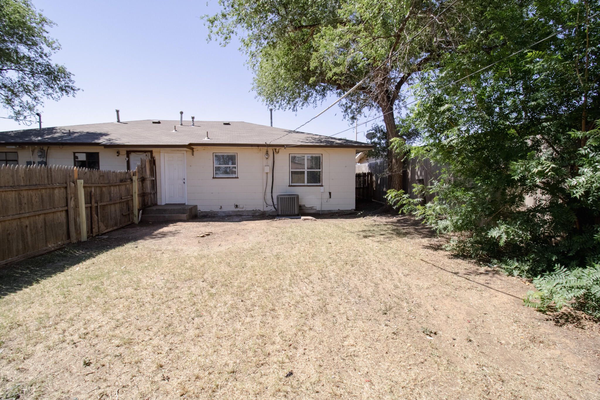 2906 43rd Street, Unit B Lubbock, TX 79413 - Photo 8 of 8 a front view of a house with a yard and garage