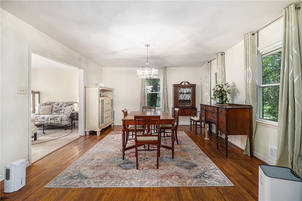2545 Rockbridge Road Northwest Conyers, GA 30012 - Photo 11 of 61 a dining room with wooden floor and large windows