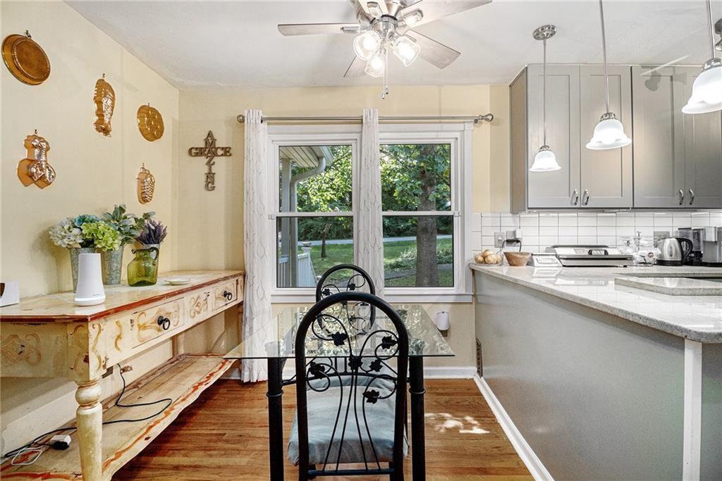 2545 Rockbridge Road Northwest Conyers, GA 30012 - Photo 16 of 61 a kitchen with granite countertop a sink appliances cabinets and a large window