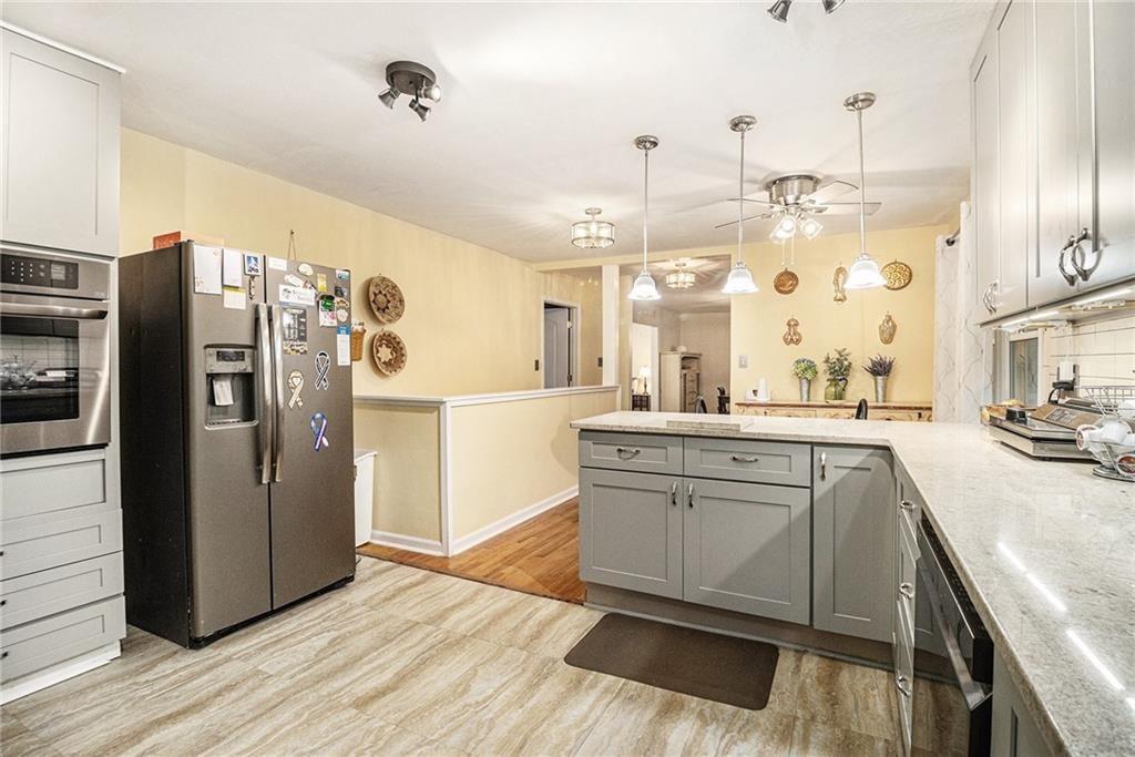 2545 Rockbridge Road Northwest Conyers, GA 30012 - Photo 21 of 61 a view of a kitchen with refrigerator and wooden floor