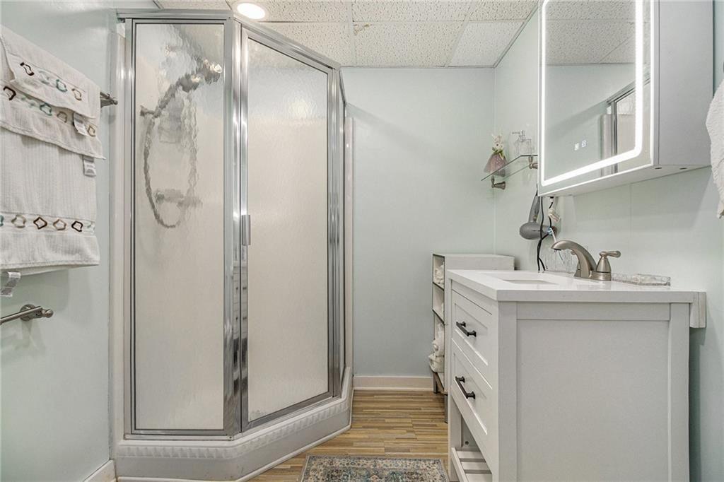 2545 Rockbridge Road Northwest Conyers, GA 30012 - Photo 30 of 61 a bathroom with a sink a mirror and shower