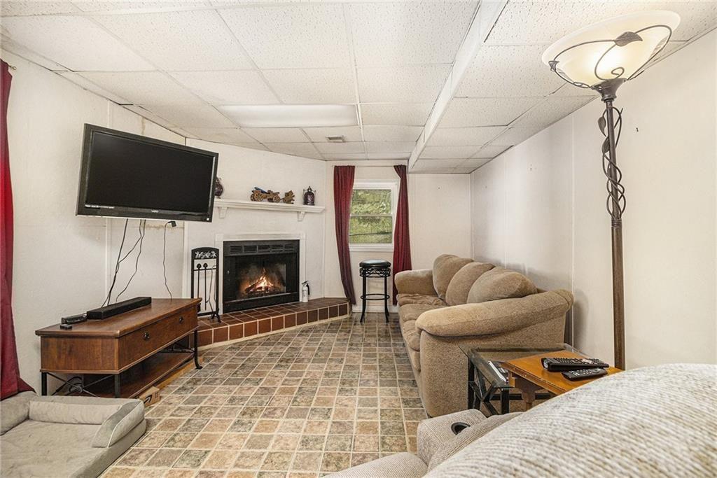 2545 Rockbridge Road Northwest Conyers, GA 30012 - Photo 33 of 61 a living room with furniture a flat screen tv and a fireplace