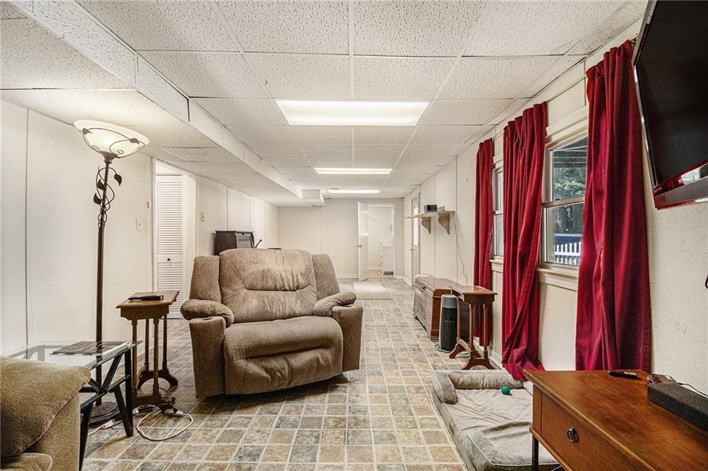 2545 Rockbridge Road Northwest Conyers, GA 30012 - Photo 34 of 61 a living room with furniture and a flat screen tv