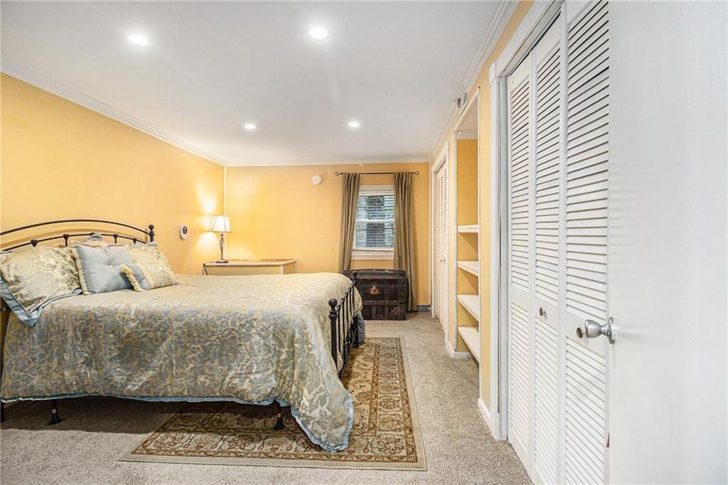 2545 Rockbridge Road Northwest Conyers, GA 30012 - Photo 38 of 61 a bedroom with a bed and wooden floor