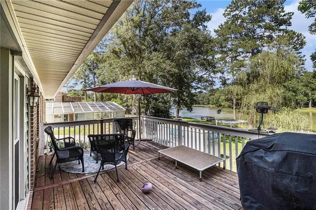 a view of balcony with furniture and umbrella