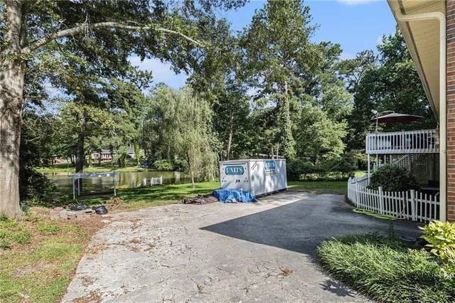 an aerial view of residential house with outdoor space and trees all around