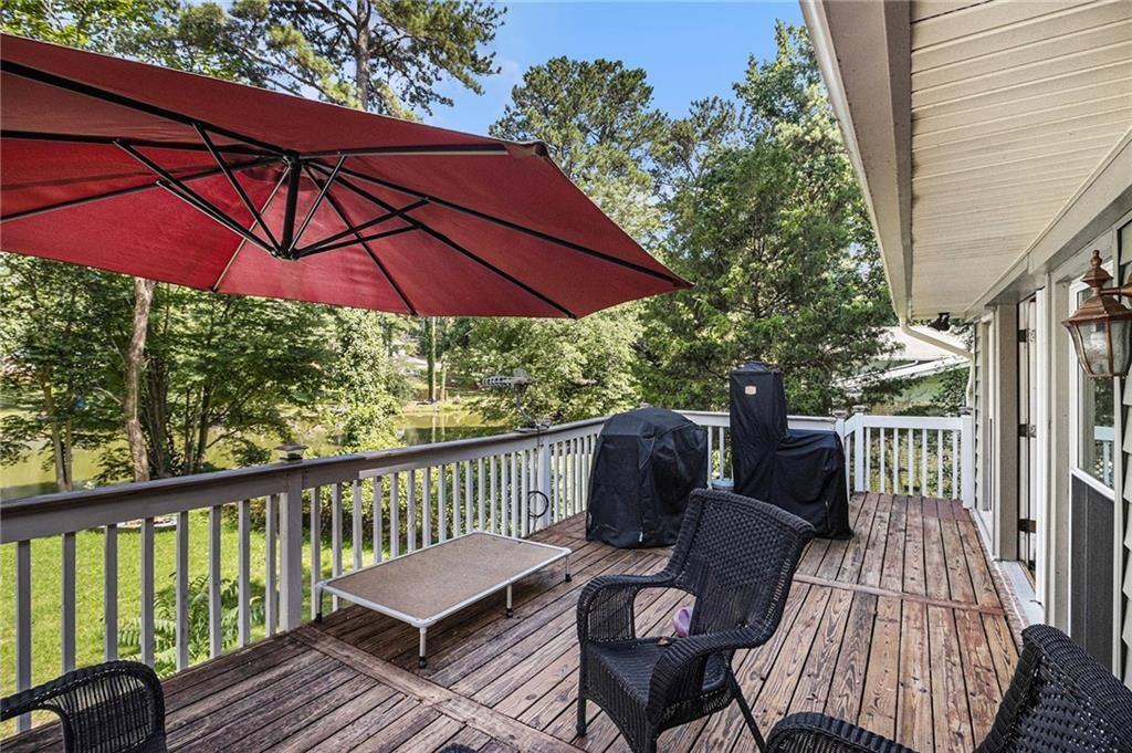 2545 Rockbridge Road Northwest Conyers, GA 30012 - Photo 50 of 61 a view of balcony with furniture and umbrella