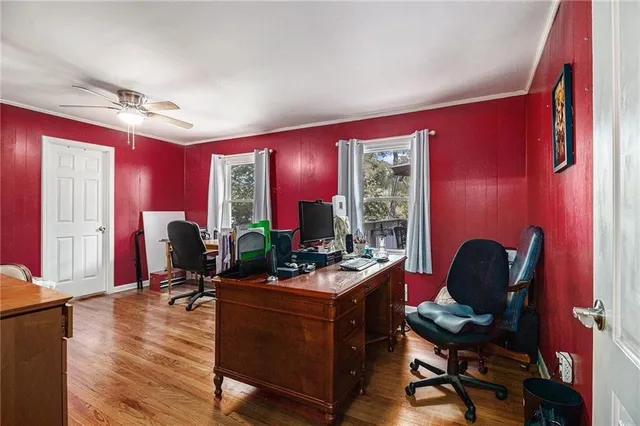 a view of a workspace with furniture and a window