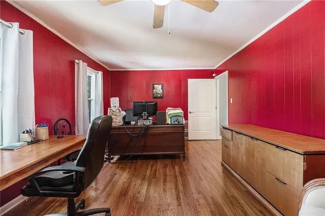a living room with furniture gym equipment and a wooden floor
