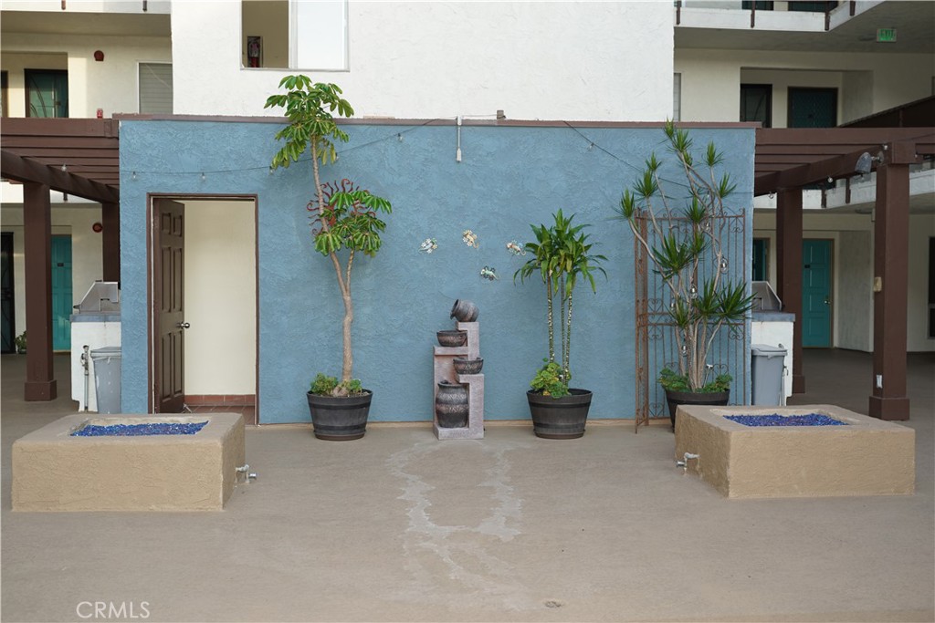 3939 East Allin, Unit 109 Long Beach, CA 90803 - Photo 16 of 21 front view of a house with potted plants