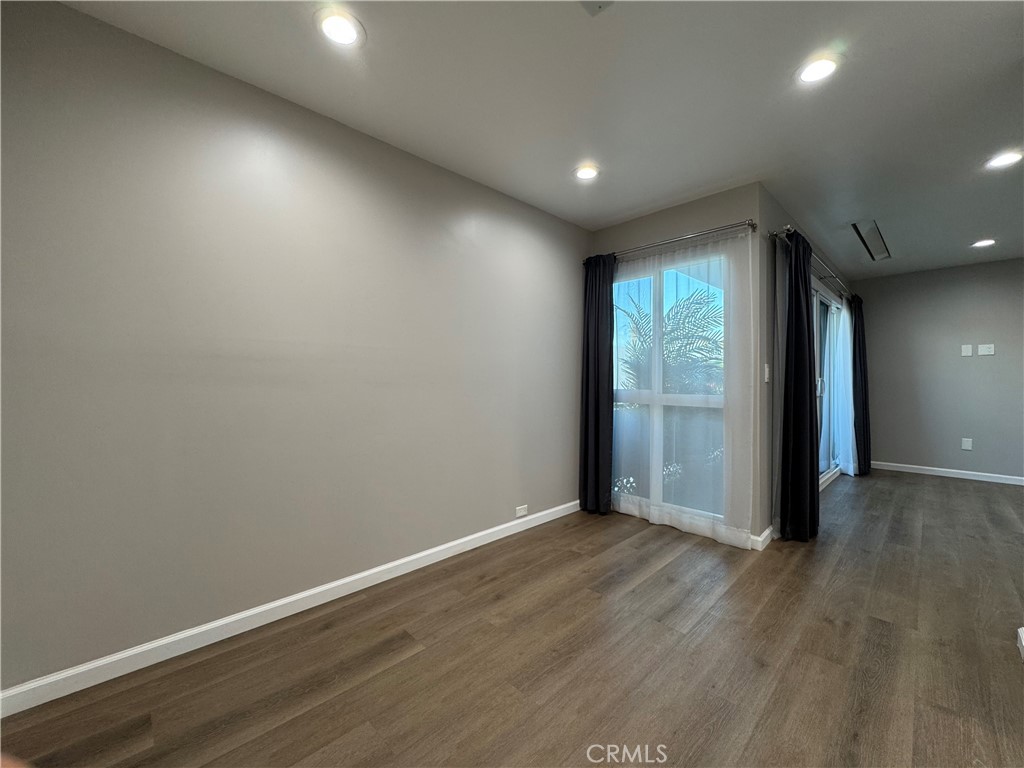 3939 East Allin, Unit 109 Long Beach, CA 90803 - Photo 3 of 21 an empty room with wooden floor and windows