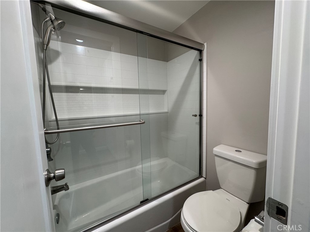 3939 East Allin, Unit 109 Long Beach, CA 90803 - Photo 7 of 21 a white toilet sitting next to a bathtub