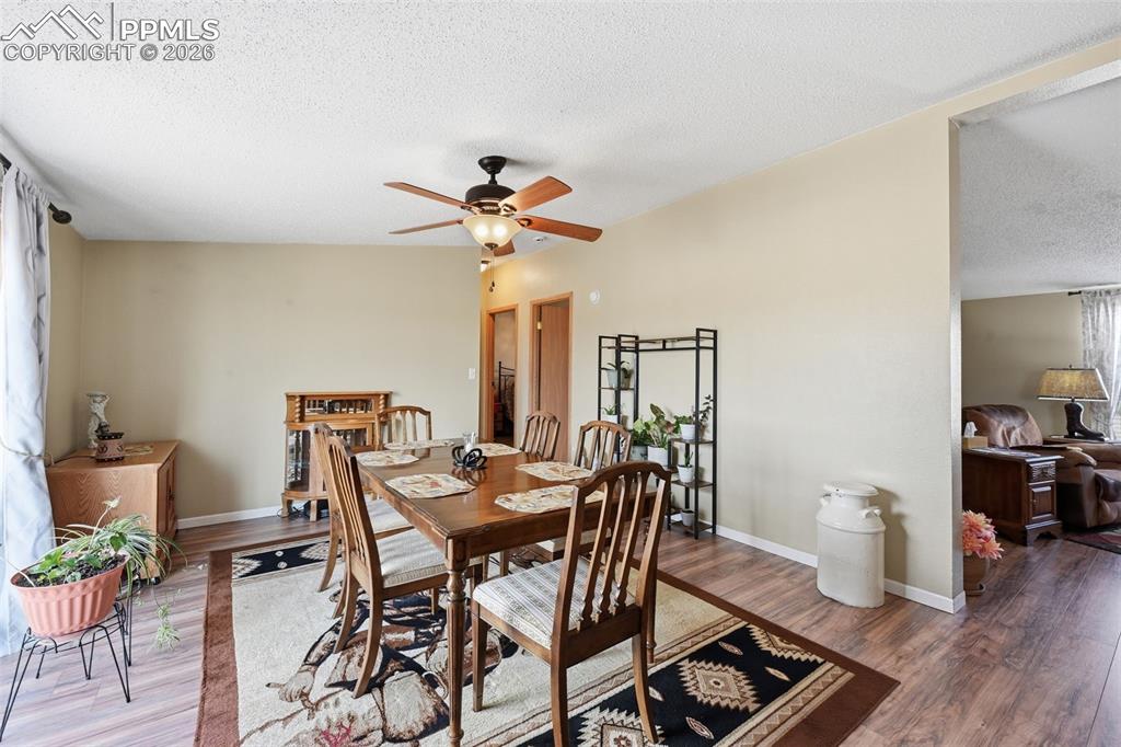 20985 McDaniels Road Calhan, CO 80808 - Photo 26 of 41 a view of a dining room with furniture and wooden floor