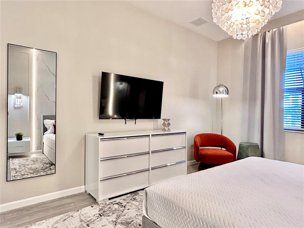 6271 Sand Skipper Road Orlando, FL 32821 - Photo 14 of 46 a bedroom with a bed and a flat screen tv