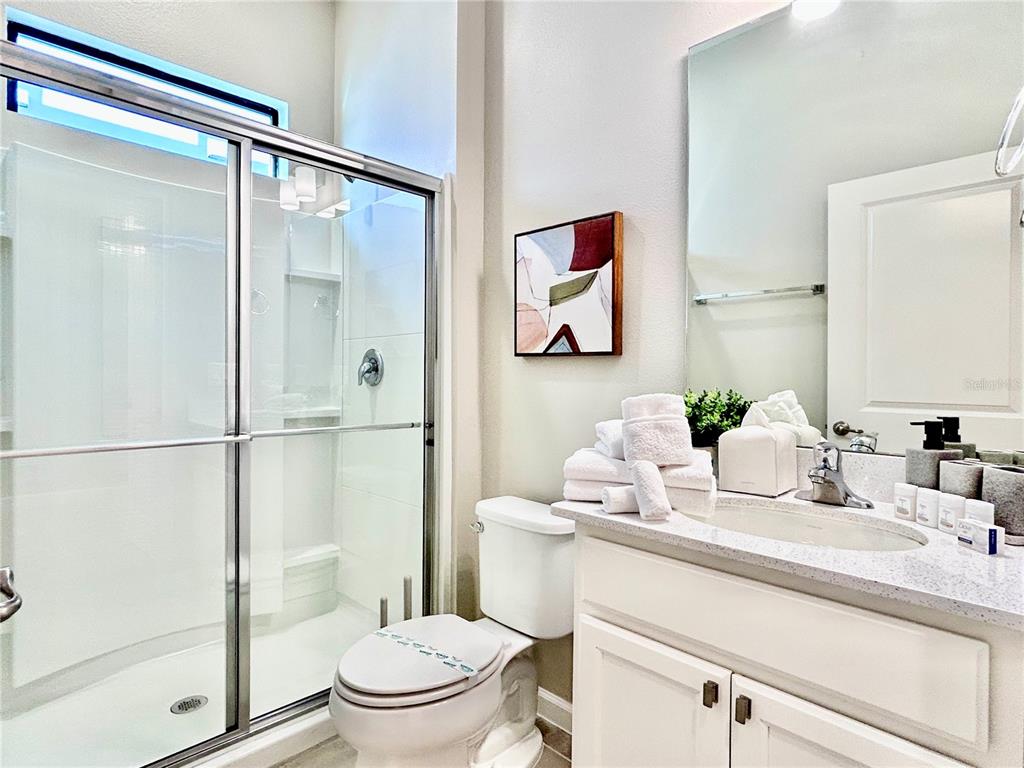 6271 Sand Skipper Road Orlando, FL 32821 - Photo 21 of 46 a bathroom with a sink toilet and shower