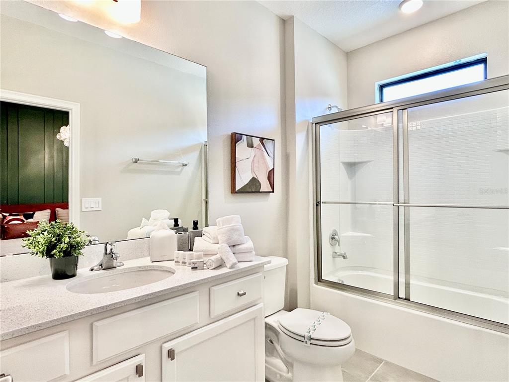 6271 Sand Skipper Road Orlando, FL 32821 - Photo 27 of 46 a bathroom with a sink a toilet and shower