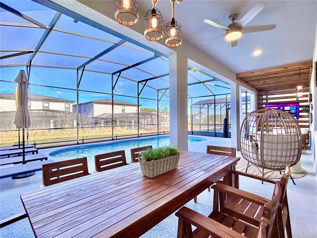 6271 Sand Skipper Road Orlando, FL 32821 - Photo 3 of 46 a living room with furniture a rug and a chandelier