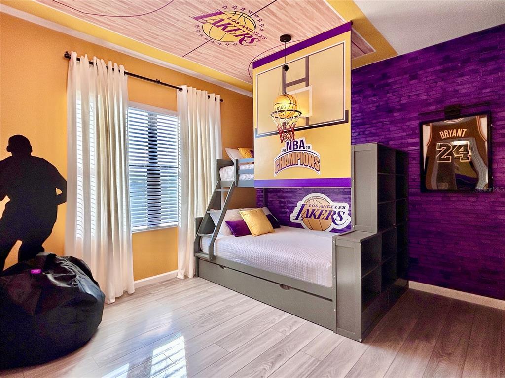 6271 Sand Skipper Road Orlando, FL 32821 - Photo 32 of 46 a bedroom with a bed and wooden floor