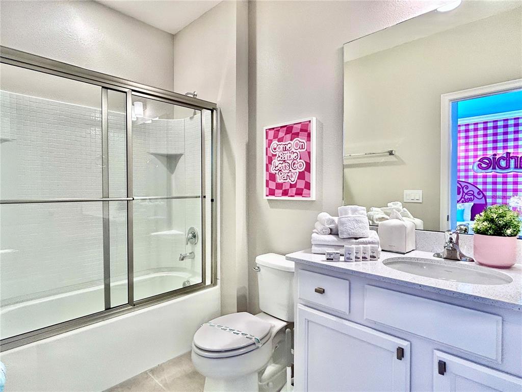 6271 Sand Skipper Road Orlando, FL 32821 - Photo 37 of 46 a bathroom with a granite countertop sink a toilet and shower