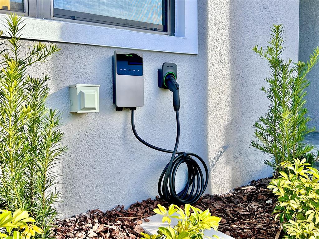 6271 Sand Skipper Road Orlando, FL 32821 - Photo 41 of 46 a table with a vase of flowers sitting on a table and a potted plant