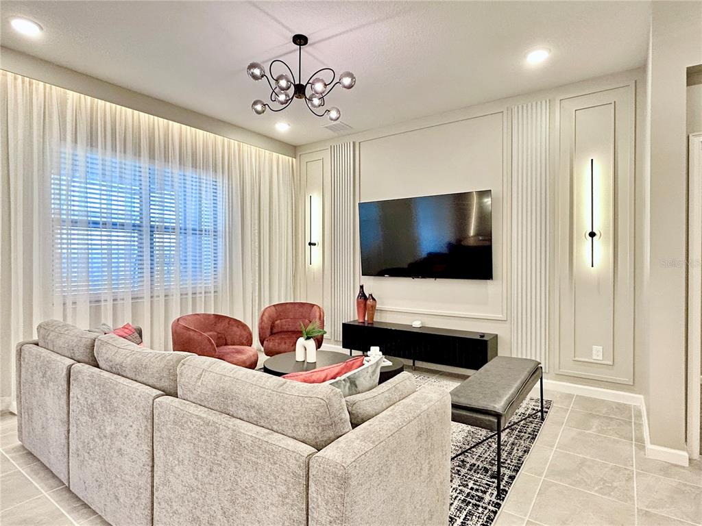 6271 Sand Skipper Road Orlando, FL 32821 - Photo 7 of 46 a living room with furniture and a flat screen tv