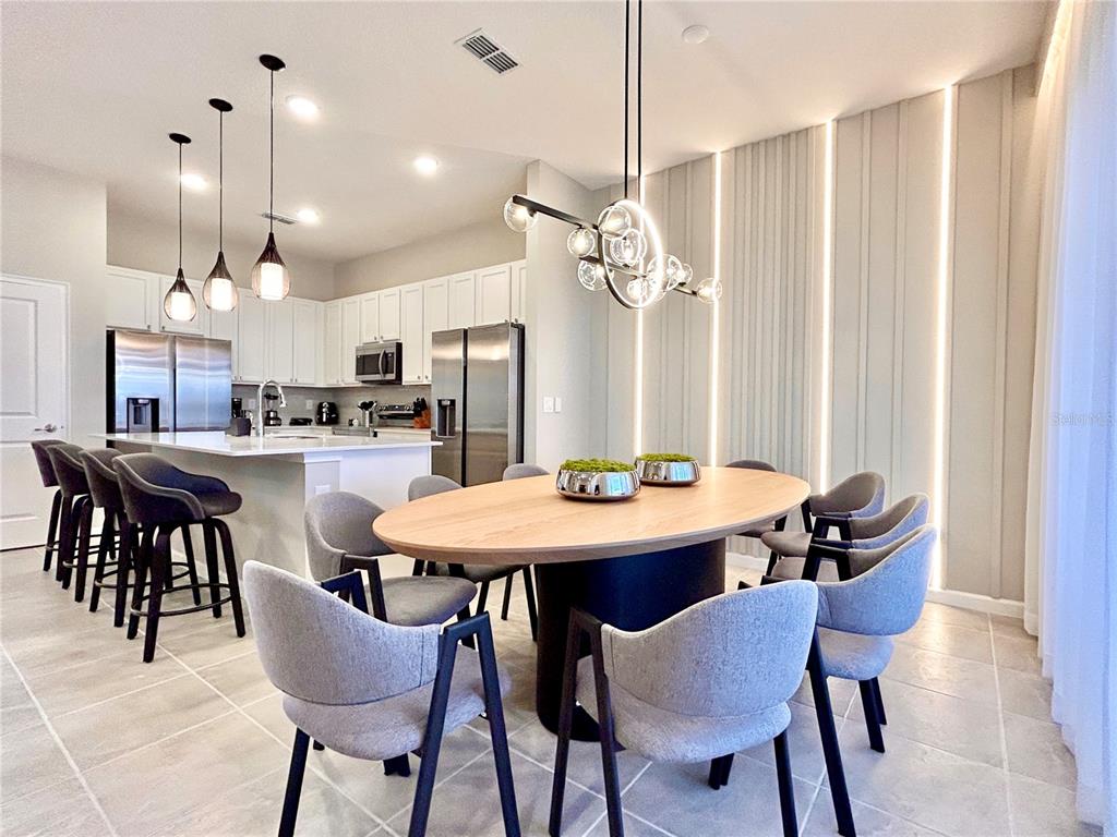 6271 Sand Skipper Road Orlando, FL 32821 - Photo 10 of 46 a view of a dining room with furniture and a chandelier