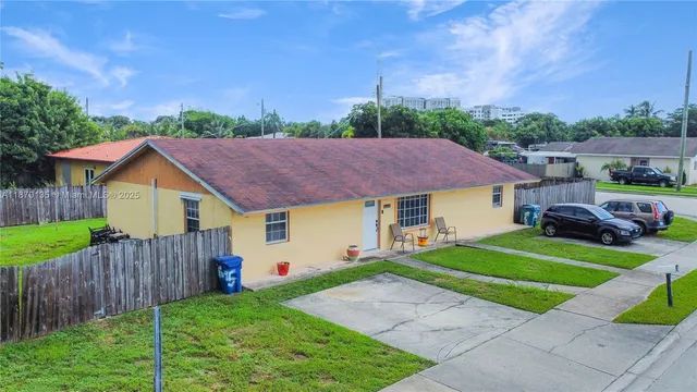 a view of a house with a yard and a garden