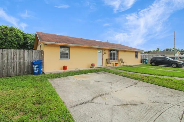 a aerial view of a house with a yard and plants