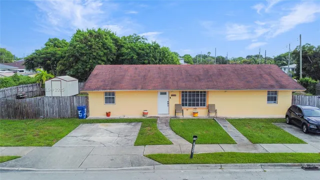 a view of yard with swimming pool and green space