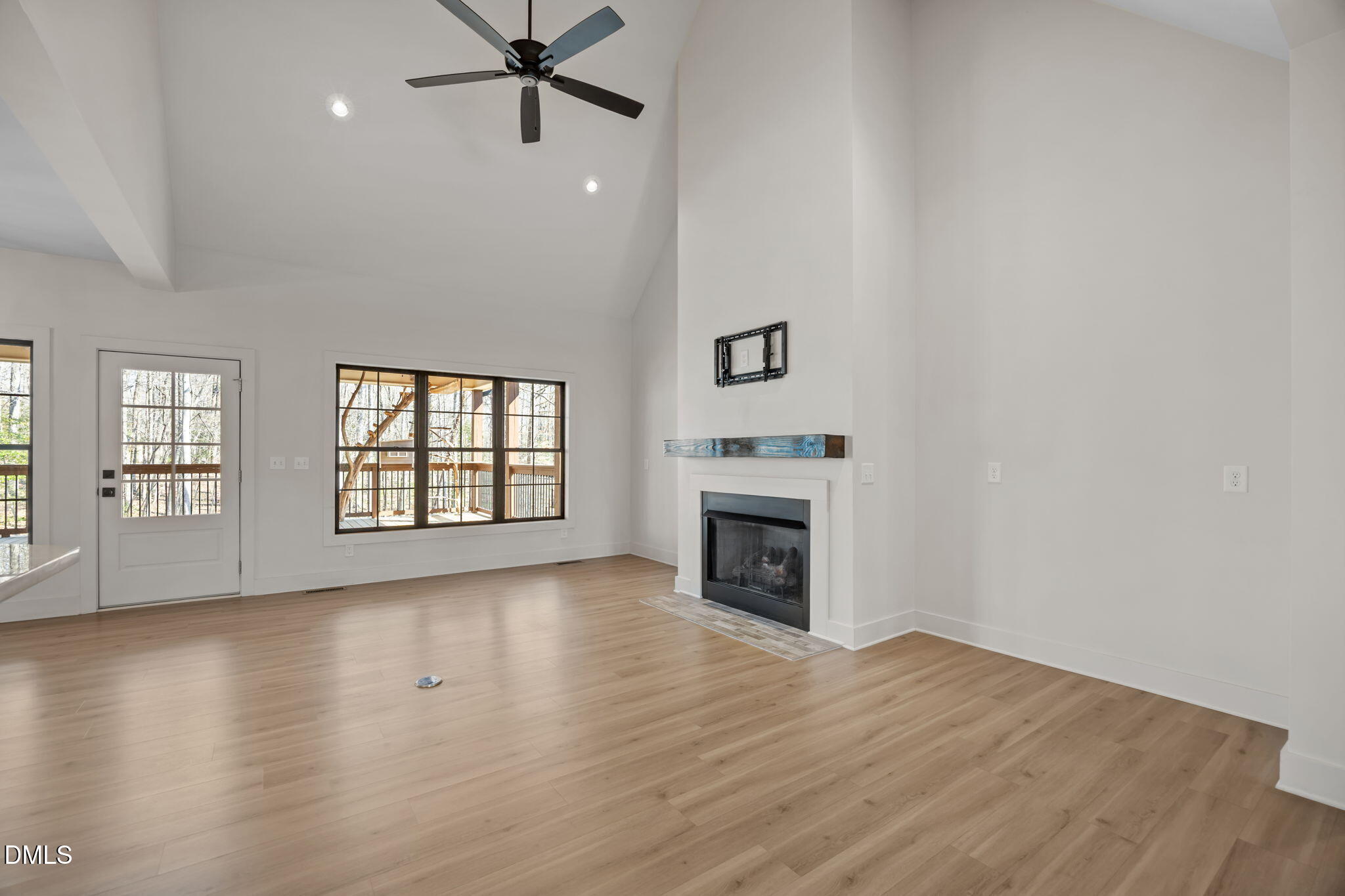 6450 Moores Mill Road Rougemont, NC 27572 - Photo 16 of 66 a view of empty room with wooden floor and fireplace