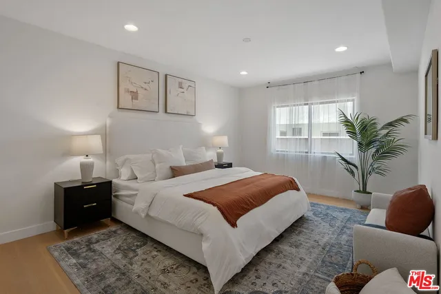 a bedroom with a large bed and a couch