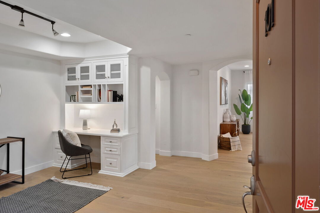 1629 Armacost Avenue, Unit 101 Los Angeles, CA 90025 - Photo 2 of 26 a view of a livingroom with furniture and workspace
