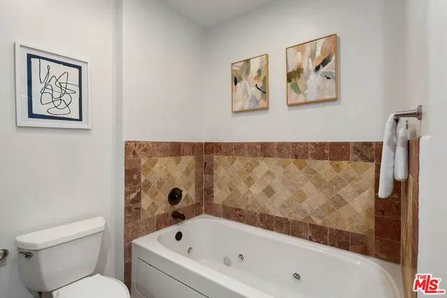 a bathroom with a bathtub and a toilet
