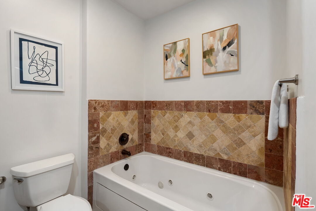 1629 Armacost Avenue, Unit 101 Los Angeles, CA 90025 - Photo 21 of 26 a bathroom with a bathtub and a toilet