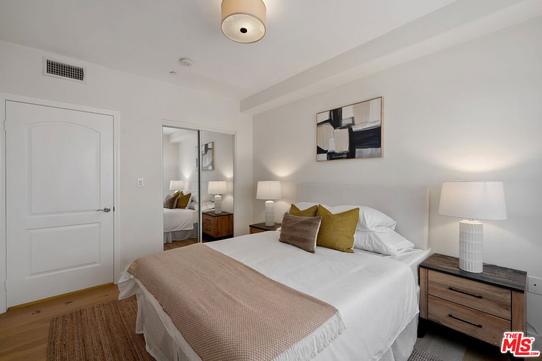 1629 Armacost Avenue, Unit 101 Los Angeles, CA 90025 - Photo 24 of 26 a bedroom with a bed and a tv