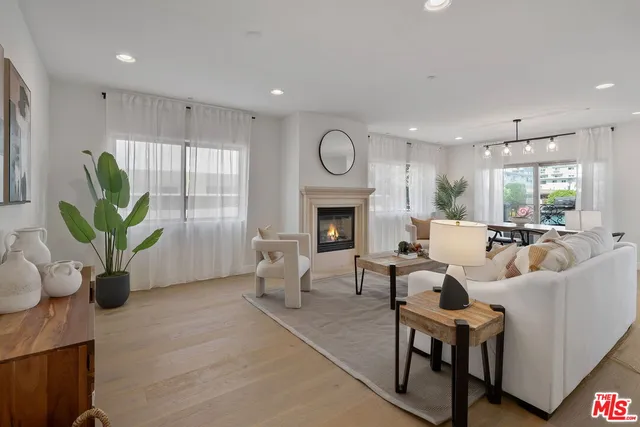 a living room with furniture fireplace and window