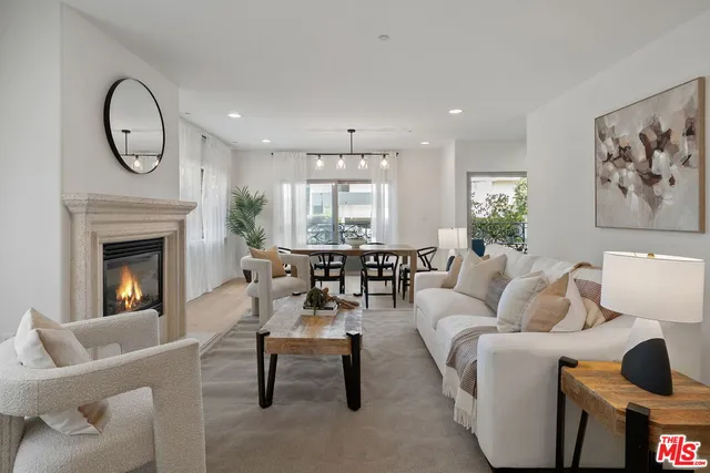 a living room with furniture a clock and a fireplace