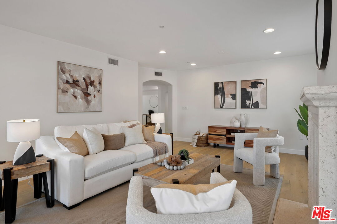 1629 Armacost Avenue, Unit 101 Los Angeles, CA 90025 - Photo 10 of 26 a living room with furniture and a white wall